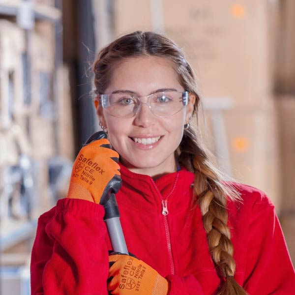 Woman in safety glasses and gloves holding a cleaning tool - Supply Chain Transparency