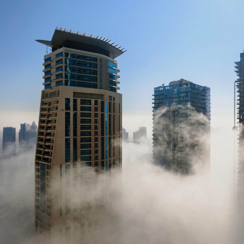 Dubai skyscrapers pierce a low-lying cloud layer. - Supply Chain Transparency