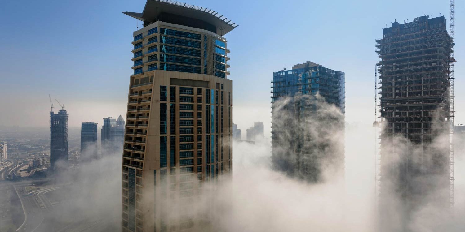 Dubai skyscrapers pierce a low-lying cloud layer. - Supply Chain Transparency