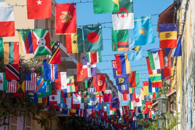 The Role of Intellectual Property Rights in International Trade Flags of various countries hang in a vibrant display, illustrating global trade and the importance of intellectual property rights. - Supply Chain Transparency