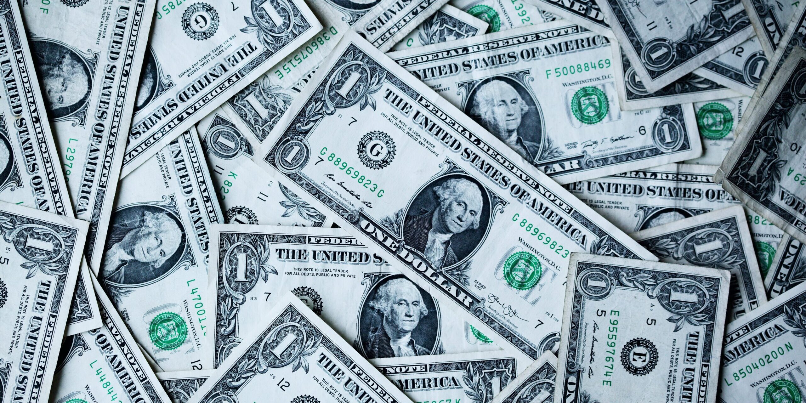 The Role of Trade Organizations: WTO, IMF, and World Bank Close-up view of a pile of one dollar bills. - Supply Chain Transparency