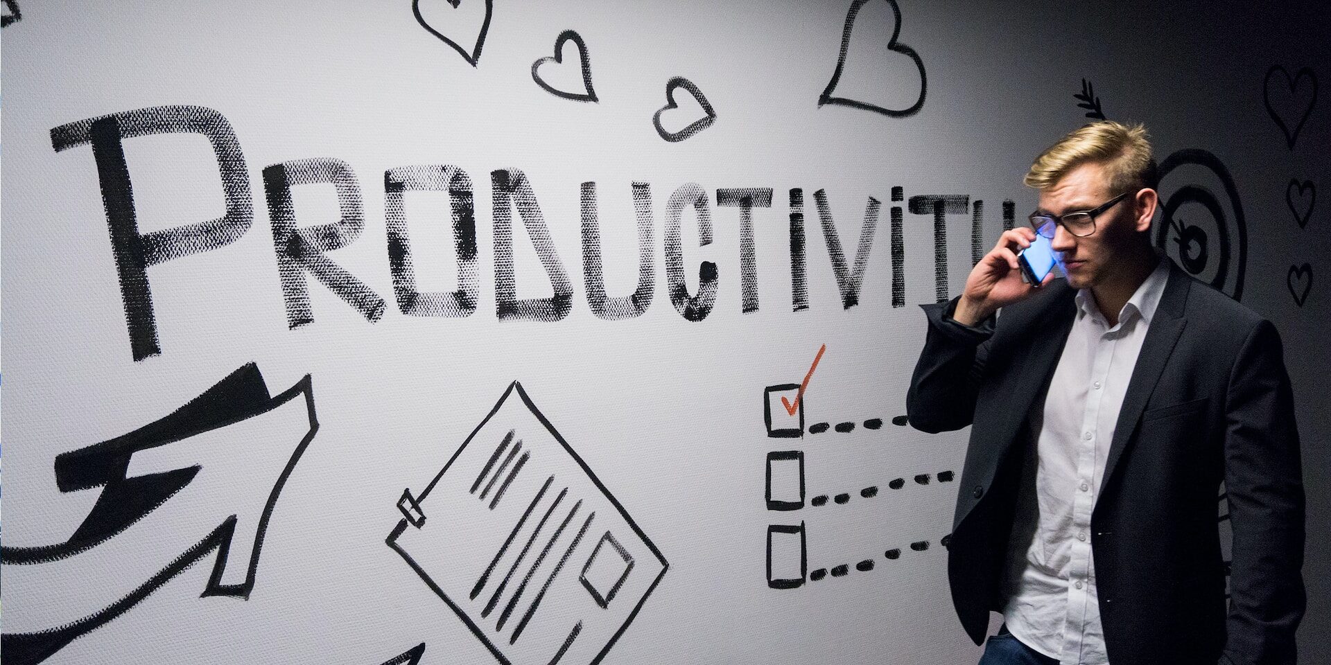 Young businessman on phone, productivity-themed wall art. - Supply Chain Transparency