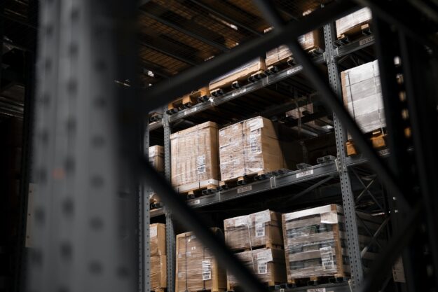 Warehouse inventory stacked on pallets, showing potential for vendor fraud. - Supply Chain Transparency