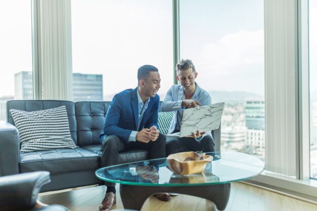Supplier Relationship Management: Building Strong Partnerships for Success Two businessmen discuss a project on a laptop, showcasing strong supplier relationship management. - Supply Chain Transparency