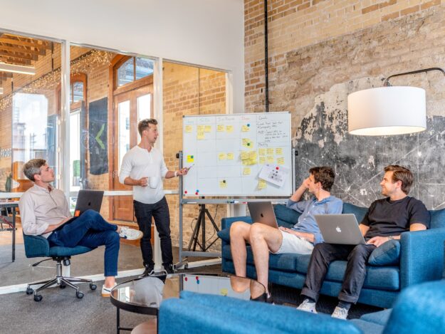 Supply Chain Collaboration: Enhancing Partnerships for Success Team collaborating on a project using a whiteboard, showcasing supply chain partnership. - Supply Chain Transparency