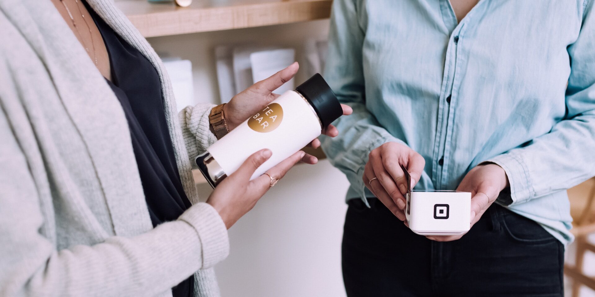 Understanding Tariffs and Trade Barriers: Implications for Global Commerce Two women at a tea bar; one holds a Tea Bar bottle, the other a payment device. - Supply Chain Transparency