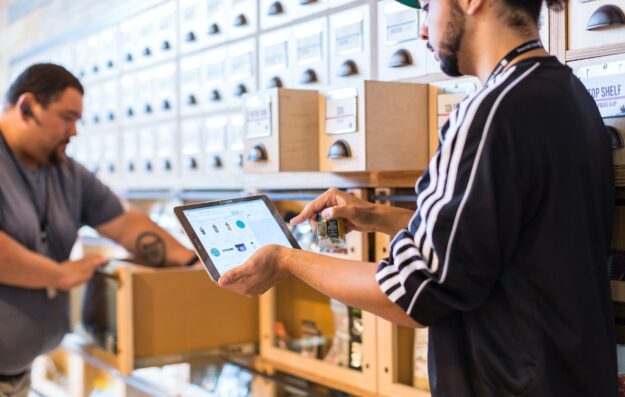 The Human Element: Addressing Employee-Related Fraud in Supply Chains Employee uses tablet to manage inventory in a warehouse, optimizing supply chain. - Supply Chain Transparency