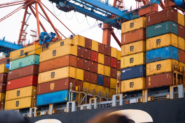 The Circular Economy and its Impact on Supply Chain Sustainability Cargo ship stacked with MSC shipping containers, illustrating global supply chain logistics and the circular economy's impact on sustainability. - Supply Chain Transparency