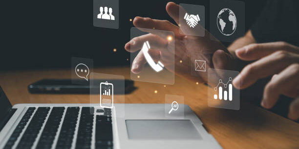 Lean Six Sigma Principles for Streamlining Supply Chain Operations Person using laptop, interacting with digital icons representing supply chain management and Lean Six Sigma principles. - Supply Chain Transparency