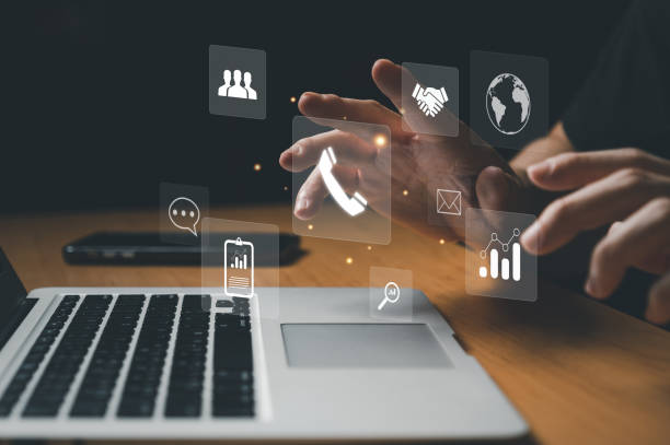 Lean Six Sigma Principles for Streamlining Supply Chain Operations Person using laptop, interacting with digital icons representing supply chain management and Lean Six Sigma principles. - Supply Chain Transparency