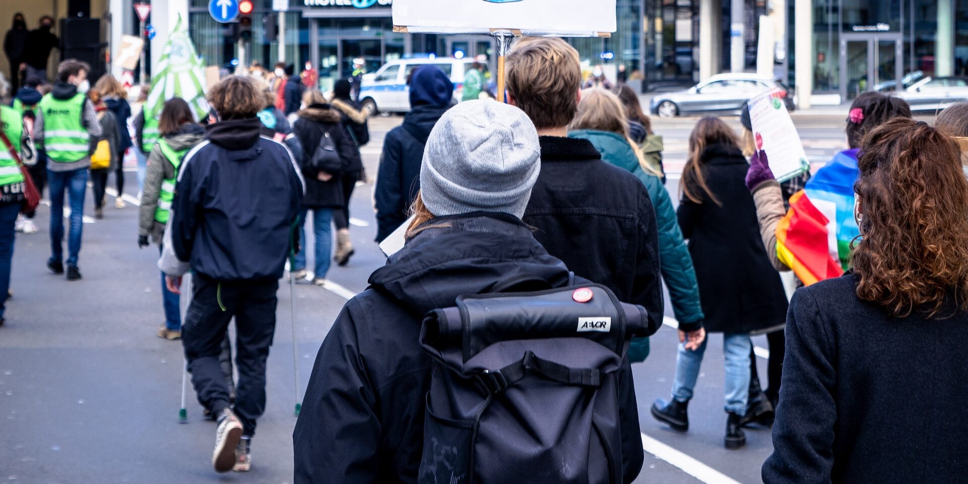 Climate protesters march, holding a sign reading "Eco not Ego". - Supply Chain Transparency