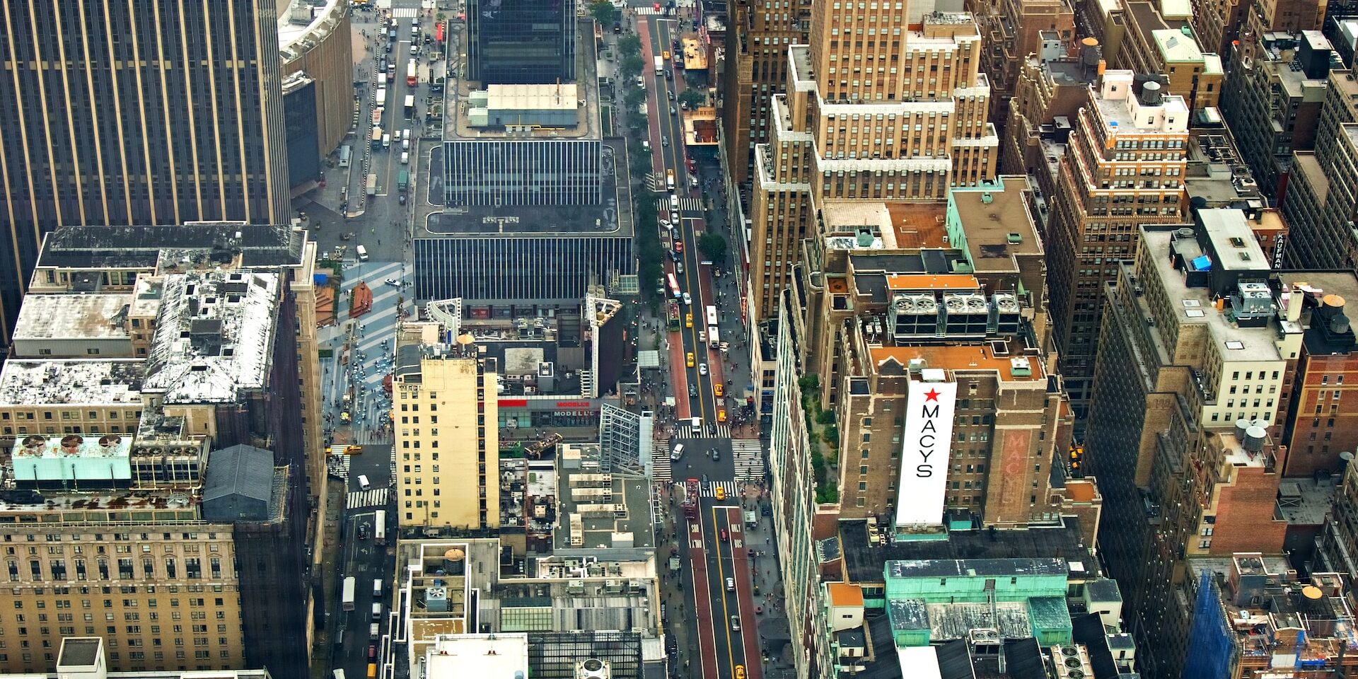 Going Above and Beyond with Supply Chain Transparency Aerial view of NYC streets and buildings, including a Macy's sign, showcasing urban density and supply chain complexity. - Supply Chain Transparency