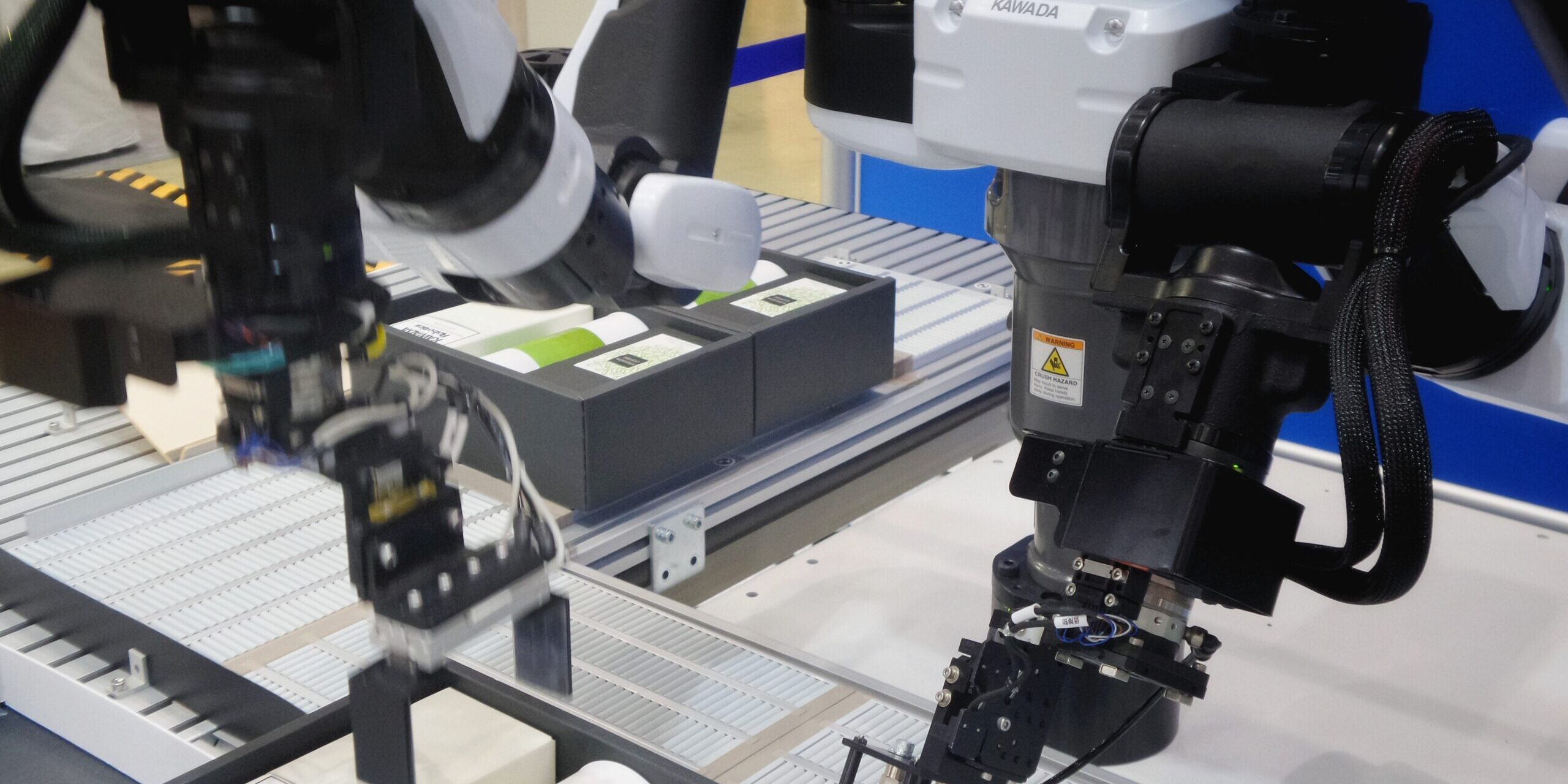 Kawada robots automate warehouse packaging, placing coffee products into boxes. - Supply Chain Transparency