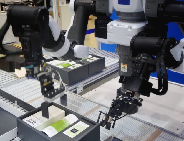 The Role of Robotics and Automation in Warehouse Operations Kawada robots automate warehouse packaging, placing coffee products into boxes. - Supply Chain Transparency