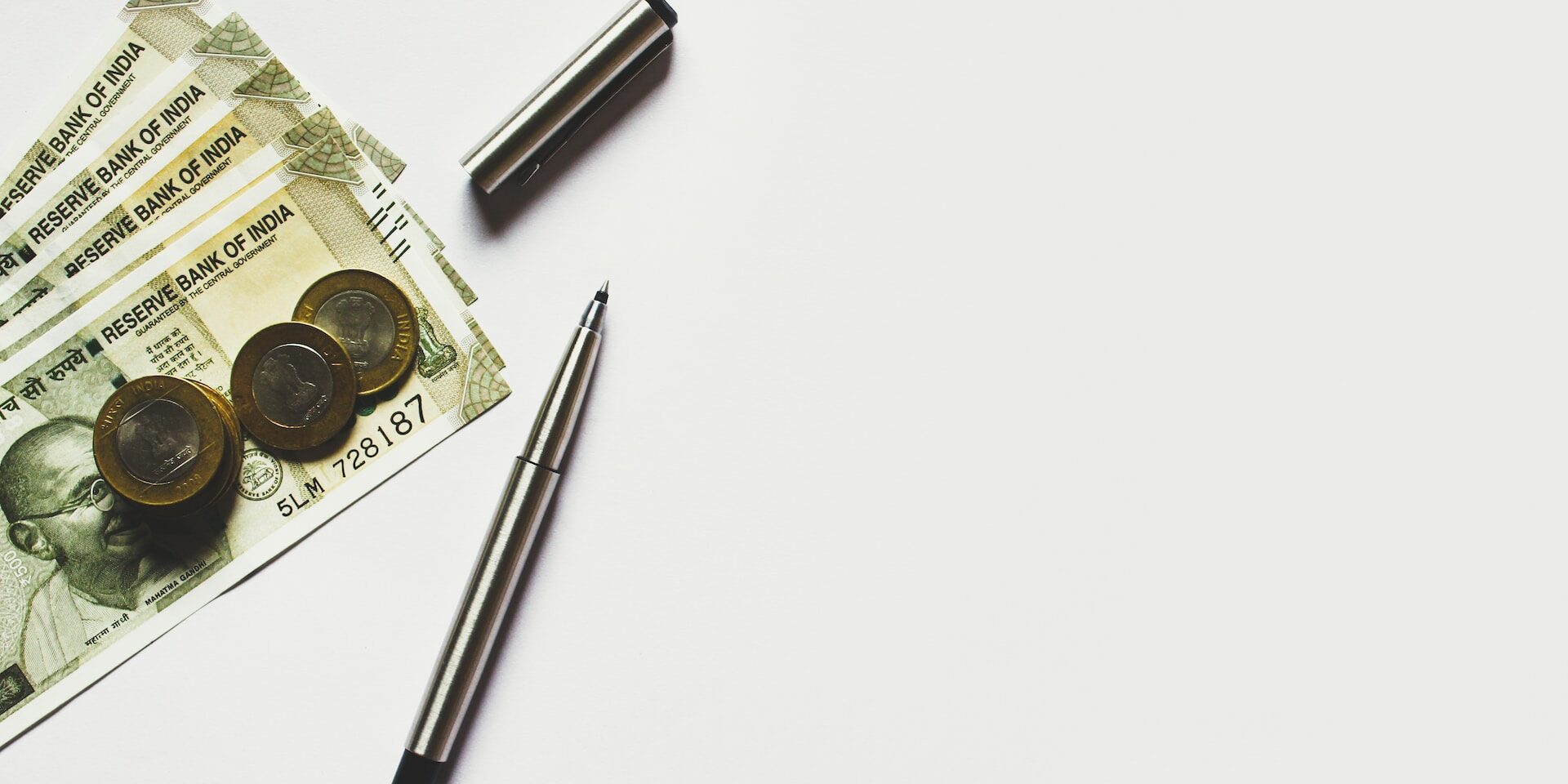 Supply Chain Finance: Enhancing Cash Flow and Reducing Risk Indian rupees, coins, and pens on a white background. Illustrating supply chain finance. - Supply Chain Transparency